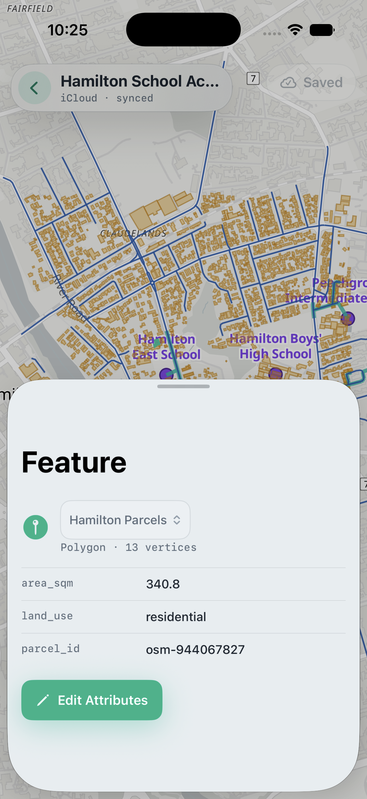 Meridian on iPhone with a parcel selected and its Feature sheet open, showing geometry details, area, land use, parcel ID, and the Edit Attributes action.
